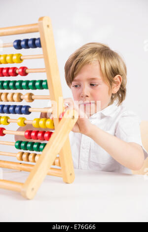 Student doing maths on abacus Stock Photo