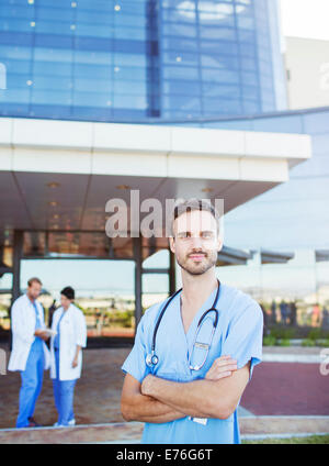 Nurse standing outside hospital Stock Photo