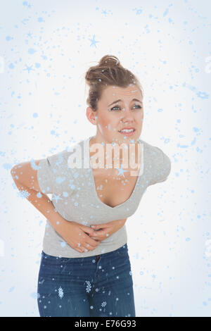 Composite image of woman suffering from menstruation pain Stock Photo