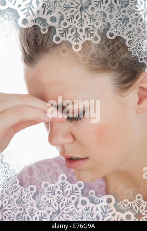 Composite image of young woman suffering from headache Stock Photo