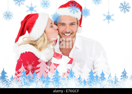 Composite image of festive young couple exchanging presents Stock Photo