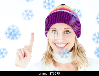 Composite image of positive woman showing up smiling at the camera against white background Stock Photo