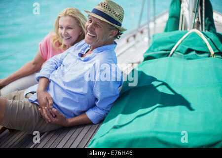 Couple sitting on boat together Stock Photo