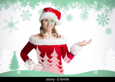 Composite image of pretty woman in santa costume presenting your product Stock Photo