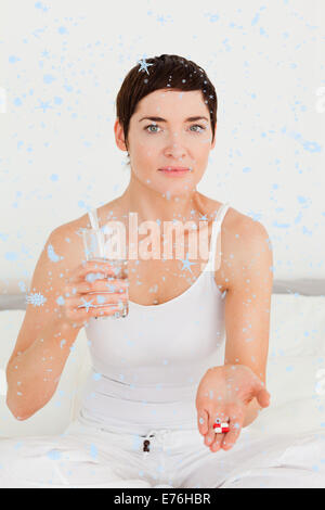 Composite image of young woman taking pills Stock Photo