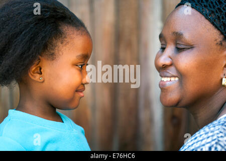 Close up portrait of African mother and daughter looking at each other. Stock Photo