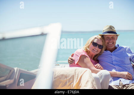 Couple sitting in boat on water Stock Photo