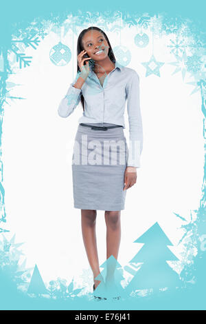 Composite image of portrait of a happy businesswoman making a phone call Stock Photo