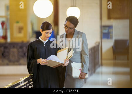 Judge and lawyer looking through documents Stock Photo