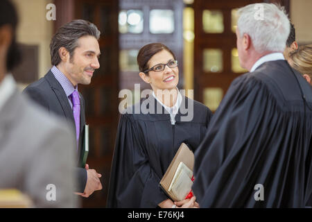 Judges and lawyers talking outside courtroom Stock Photo