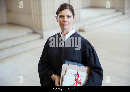 Judge holding legal documents in courthouse Stock Photo