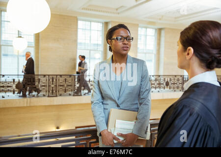 Judge and lawyer talking in courthouse Stock Photo