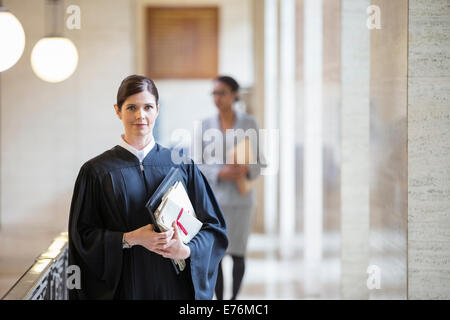 Judge holding legal documents in courthouse Stock Photo