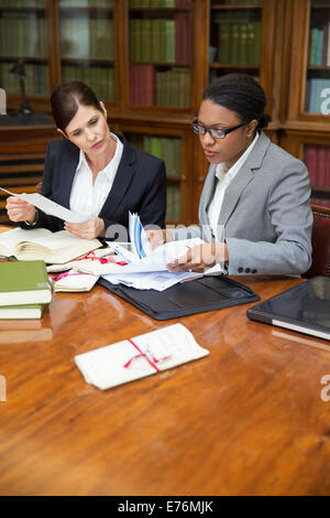 Lawyers doing research together in chambers Stock Photo