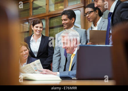 Lawyers examining document together Stock Photo