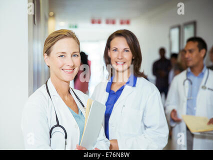 Doctors smiling in hospital hallway Stock Photo