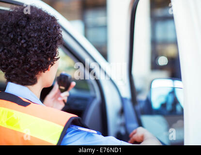 Paramedic using walkie talkie in ambulance Stock Photo