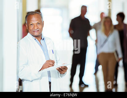 Doctor smiling in hospital Stock Photo