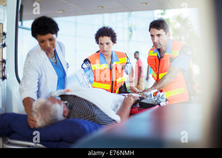 Paramedics and nurse examining patient in ambulance Stock Photo