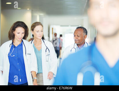 Doctors walking in hospital hallway Stock Photo