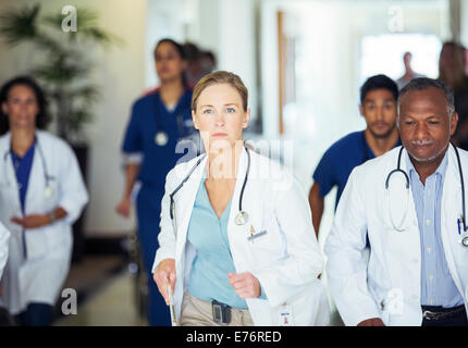 Doctors rushing in hospital hallway Stock Photo