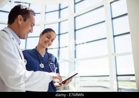 Doctor and nurse reading medical chart in hospital Stock Photo