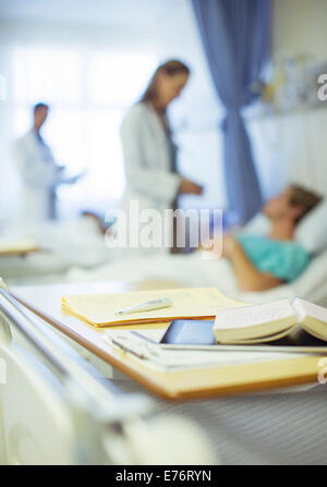 Close up of books on hospital bed tray Stock Photo