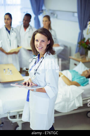 Doctor holding digital tablet in hospital room