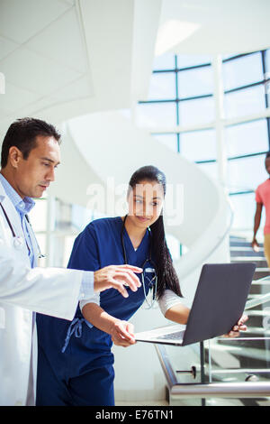 Doctor and nurse using laptop in hospital Stock Photo