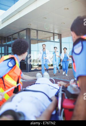 Nurses rushing to patient outside hospital Stock Photo