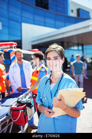 Nurse smiling outside hospital Stock Photo