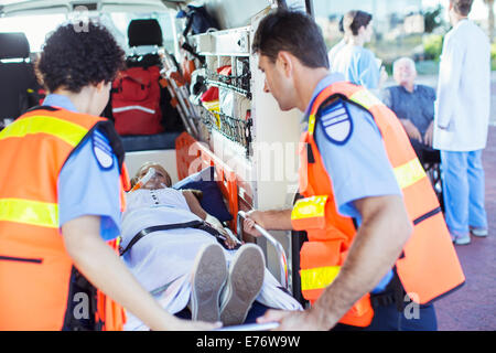 Paramedics examining patient in ambulance Stock Photo