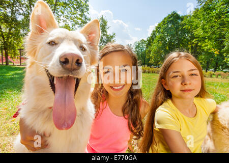 Couple happy girls with funny dog Stock Photo