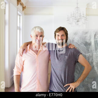 Father and son hugging indoors Stock Photo