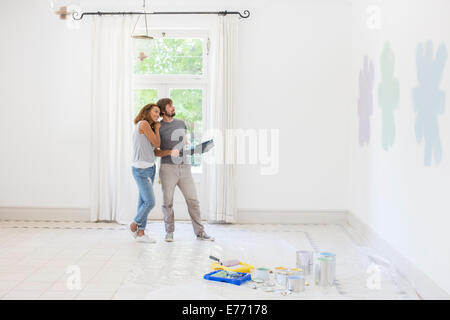Couple looking at paint swatches together Stock Photo