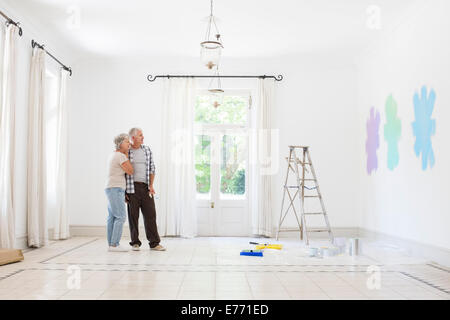 Older couple looking at paint swatches together Stock Photo