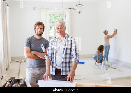 Father and son looking through construction plans Stock Photo