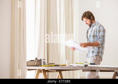 Man looking through documents Stock Photo