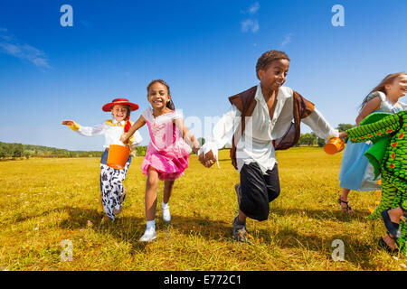 Group of kids running in Halloween costumes Stock Photo