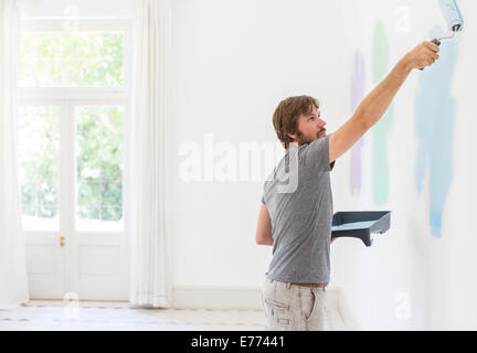 Man painting wall in living space Stock Photo