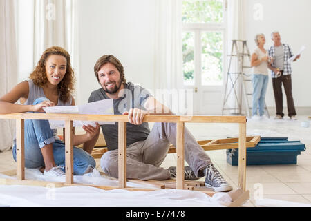 Couple building furniture together Stock Photo