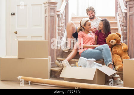 Family talking on stairs together Stock Photo
