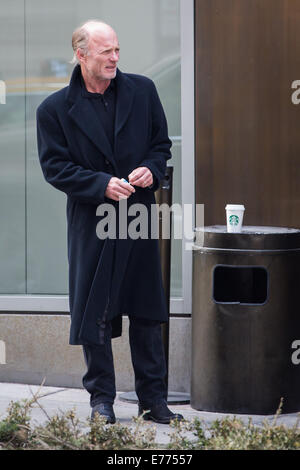 An unshaven Ed Harris lights up a cigarette while taking a coffee break, resting his cup on a trash bin outside his hotel  Featuring: Ed Harris Where: New York City, New York, United States When: 05 Mar 2014 Stock Photo