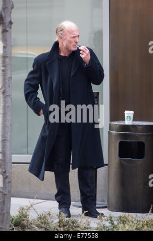 An unshaven Ed Harris lights up a cigarette while taking a coffee break, resting his cup on a trash bin outside his hotel  Featuring: Ed Harris Where: New York City, New York, United States When: 05 Mar 2014 Stock Photo