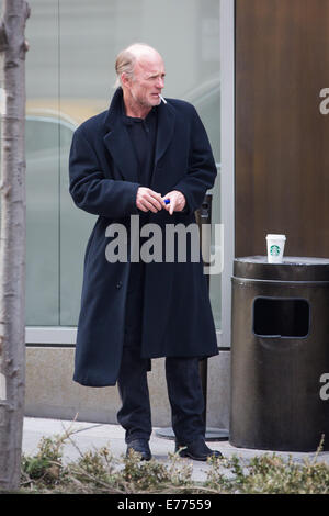 An unshaven Ed Harris lights up a cigarette while taking a coffee break, resting his cup on a trash bin outside his hotel  Featuring: Ed Harris Where: New York City, New York, United States When: 05 Mar 2014 Stock Photo