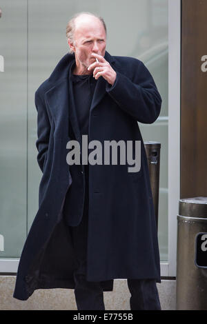 An unshaven Ed Harris lights up a cigarette while taking a coffee break, resting his cup on a trash bin outside his hotel  Featuring: Ed Harris Where: New York City, New York, United States When: 05 Mar 2014 Stock Photo