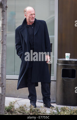 An unshaven Ed Harris lights up a cigarette while taking a coffee break, resting his cup on a trash bin outside his hotel  Featuring: Ed Harris Where: New York City, New York, United States When: 05 Mar 2014 Stock Photo