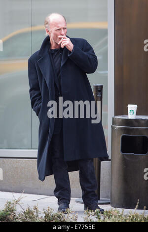 An unshaven Ed Harris lights up a cigarette while taking a coffee break, resting his cup on a trash bin outside his hotel  Featuring: Ed Harris Where: New York City, New York, United States When: 05 Mar 2014 Stock Photo