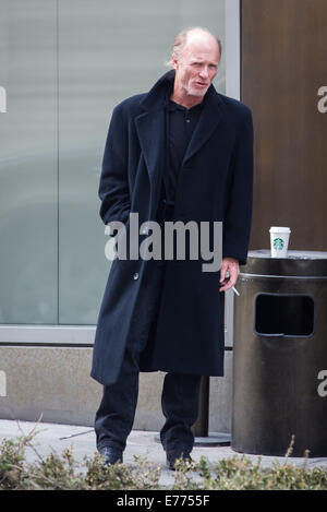 An unshaven Ed Harris lights up a cigarette while taking a coffee break, resting his cup on a trash bin outside his hotel  Featuring: Ed Harris Where: New York City, New York, United States When: 05 Mar 2014 Stock Photo