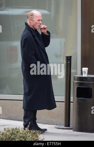 An unshaven Ed Harris lights up a cigarette while taking a coffee break, resting his cup on a trash bin outside his hotel  Featuring: Ed Harris Where: New York City, New York, United States When: 05 Mar 2014 Stock Photo